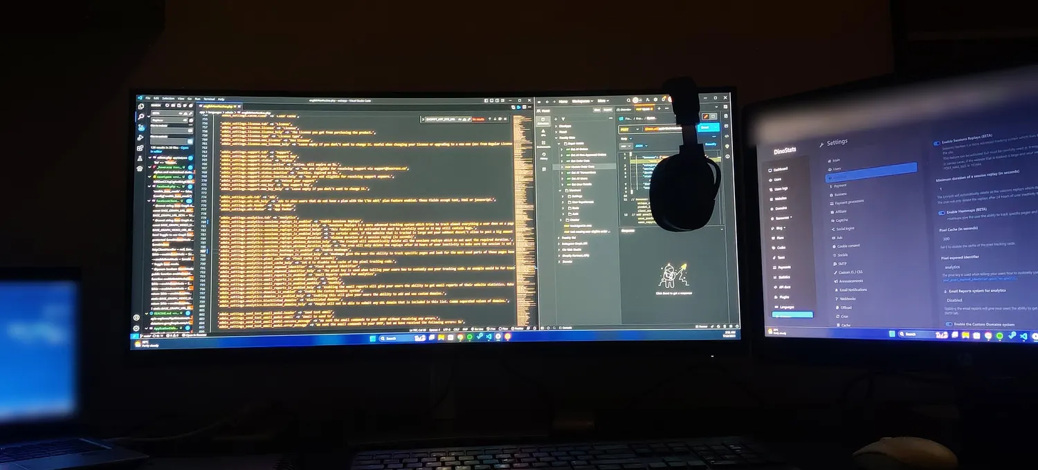 My desk at 3:51 in the morning in July 2023: an ultrawide monitor full of code, a second screen with the DinoStats admin settings, and a laptop.