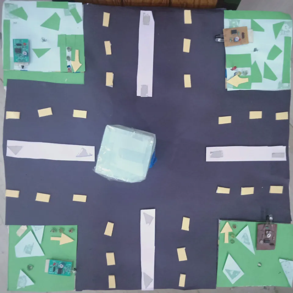 My density based traffic management model: a cardboard crossroads with a sensor board and LEDs at each corner.